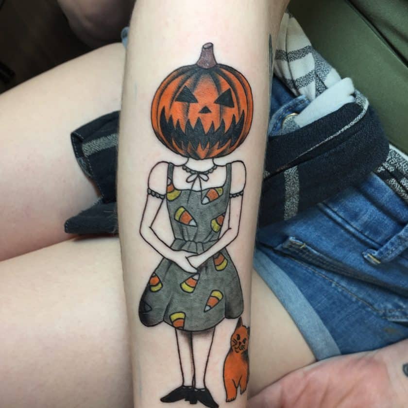 Pumpkin headed girl with candy corn dress tattoo